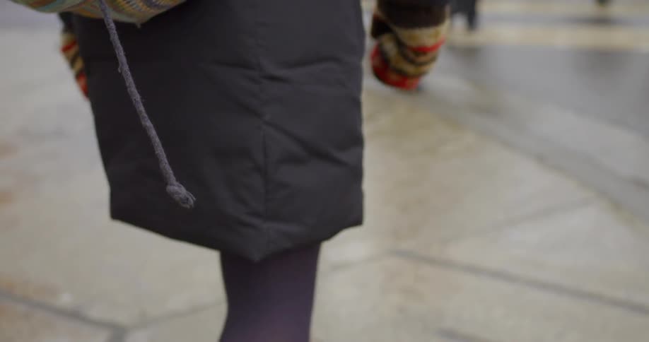 Woman walking outside with gloves