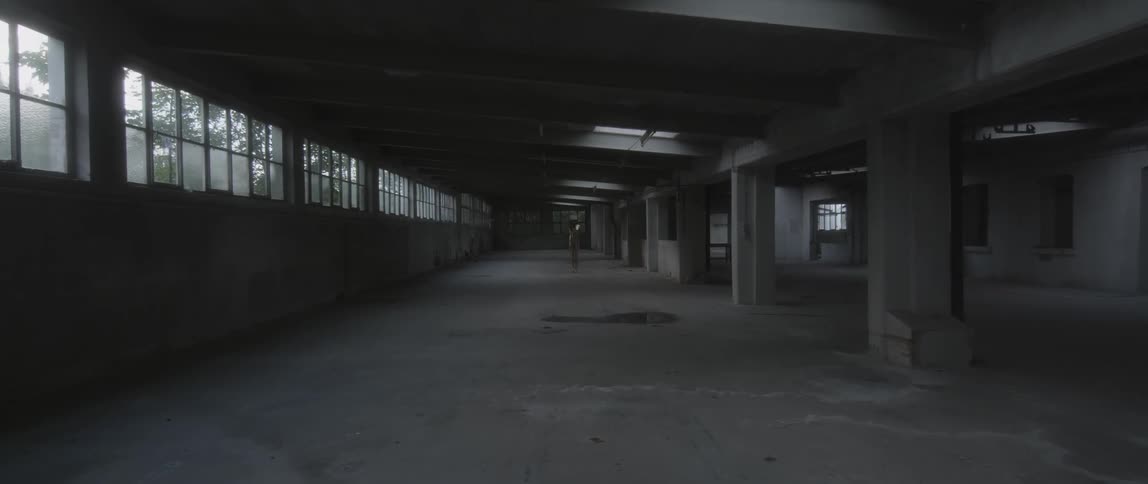 A concrete warehouse sits empty