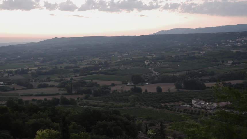 Farm land spreads out to the hills at sunset