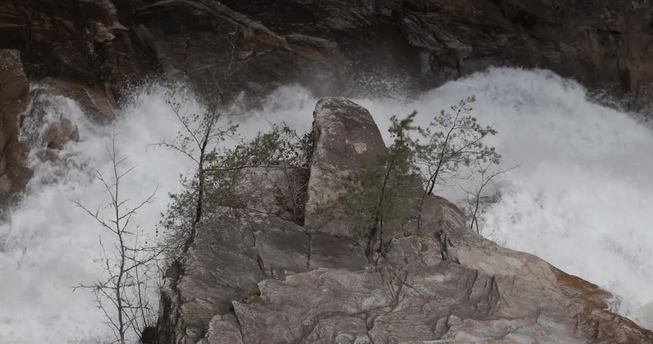 Rapids are crashing through a narrow gorge during the day