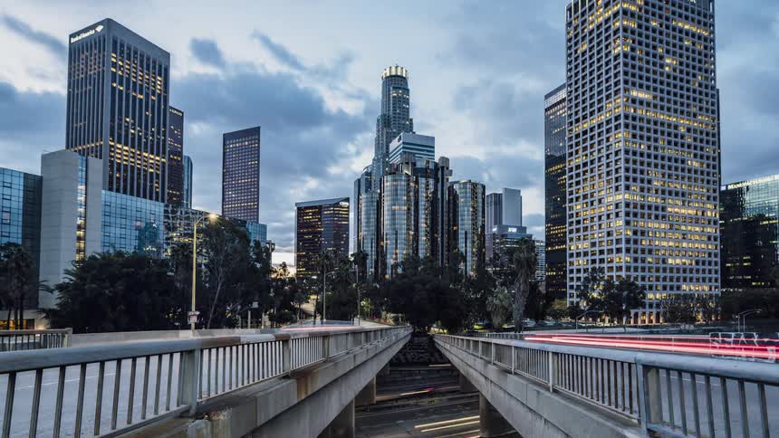 Clouds roll over the downtown of a city in the evening
