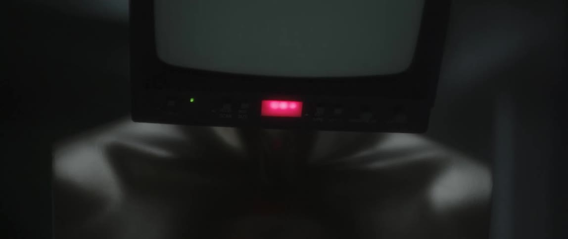 A television sits on a mannequin's head