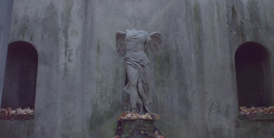 Leaves surround a headless statue