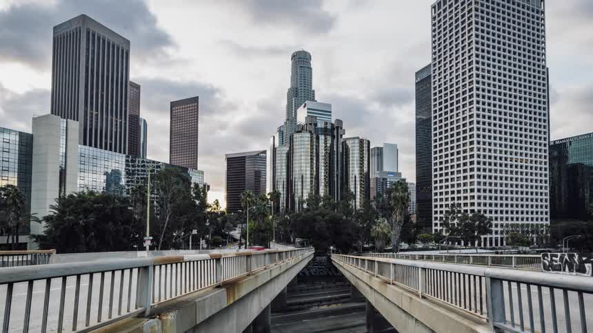 Pedestrians cross a city bridge