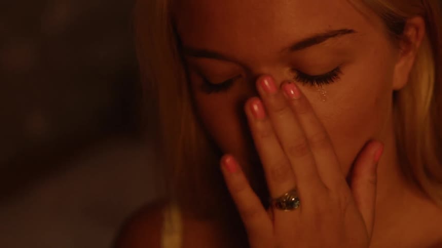 Blond woman wipes away a tear