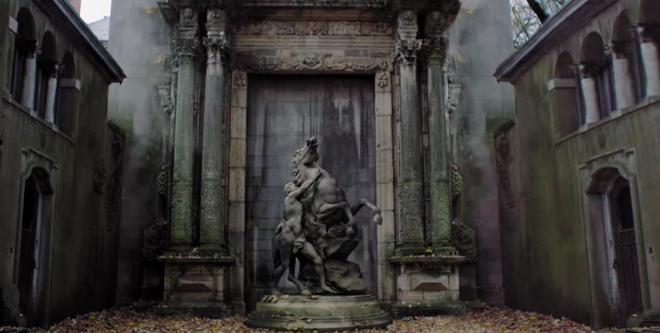 A statue is displayed in a dirty courtyard