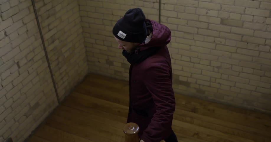 Person walking down steps with a brick wall around