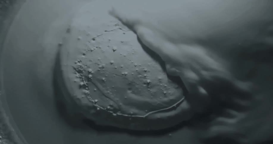 The white paint pours over the rock