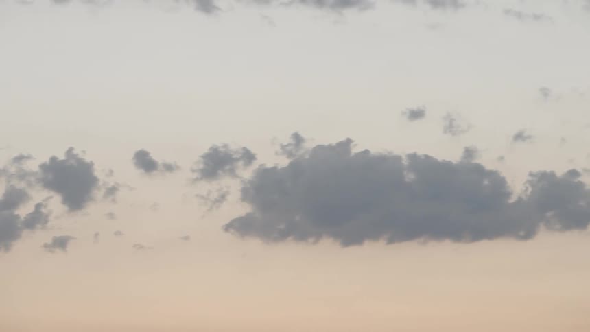Clouds float in the sky at sunset