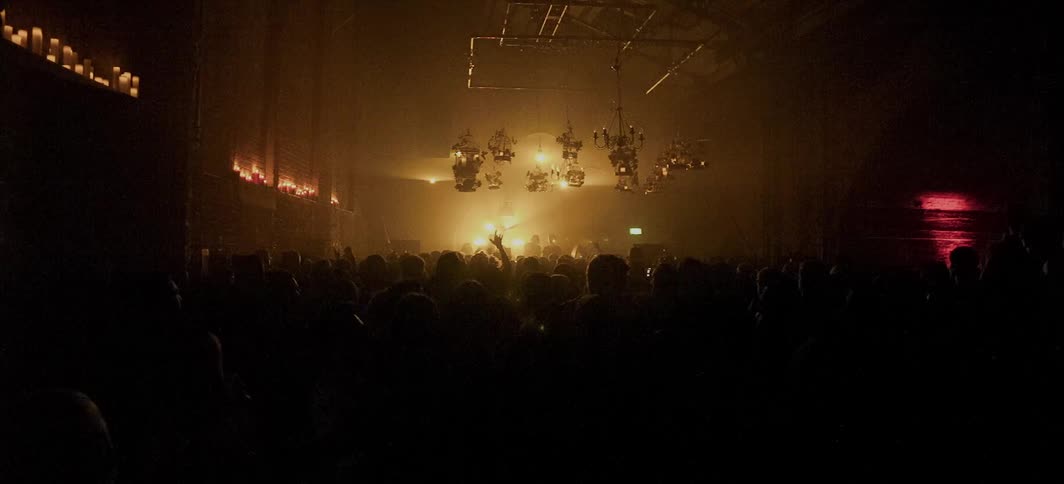 Audience watches a band perform at a concert
