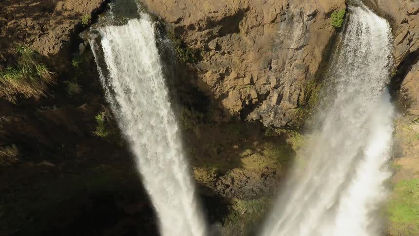 Waterfall splashes into a pool below