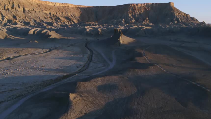 Hills and rock formations cover a desert landscape