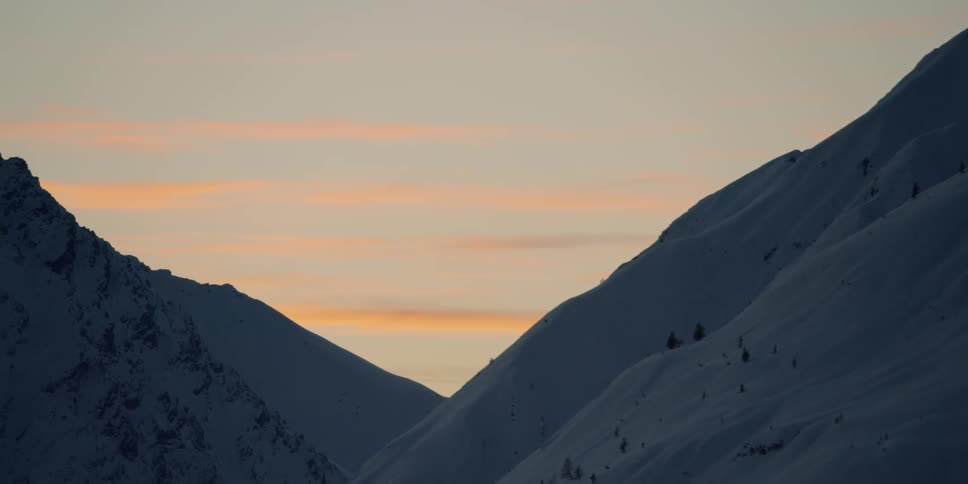 Large mountains covered in snow at sunset