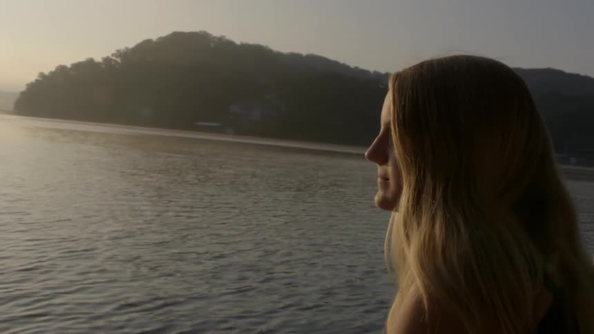 Woman looking out onto a lake