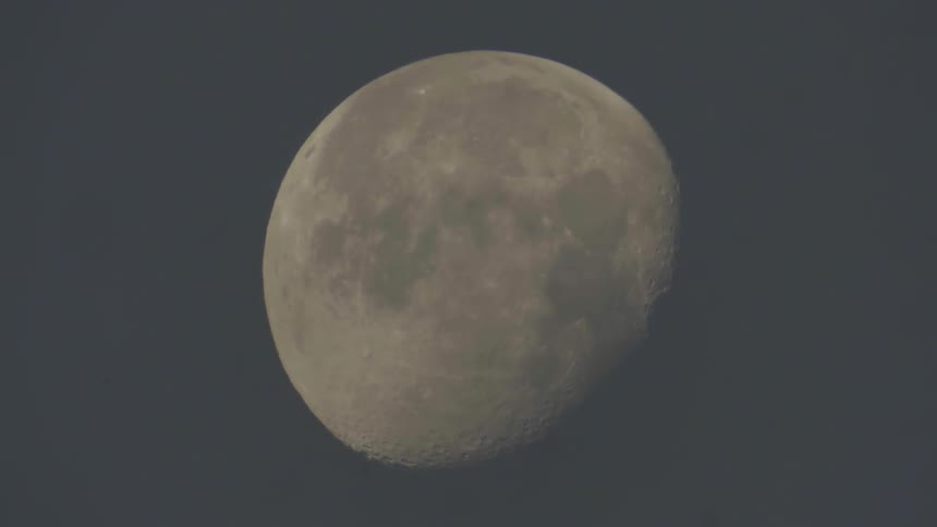 Clouds float in front of the moon