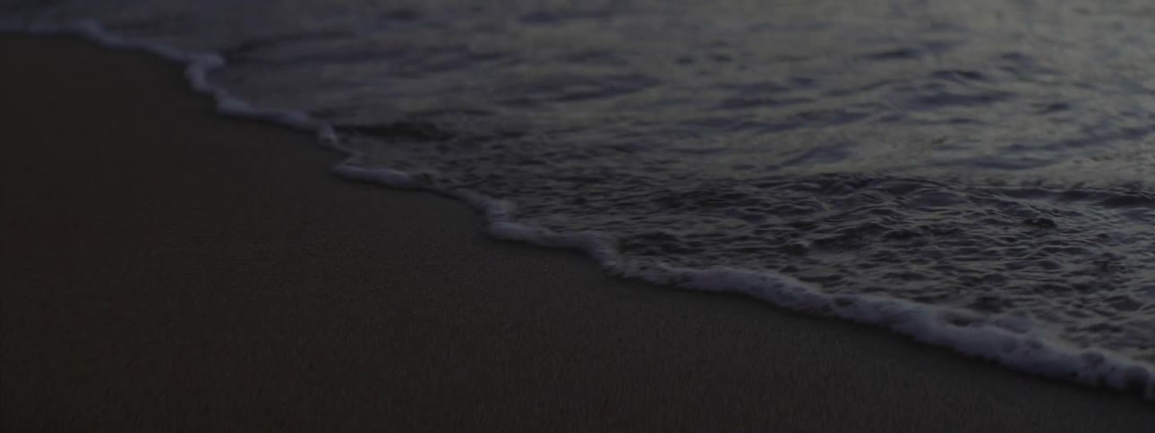 Ocean waves wash ashore a sandy beach