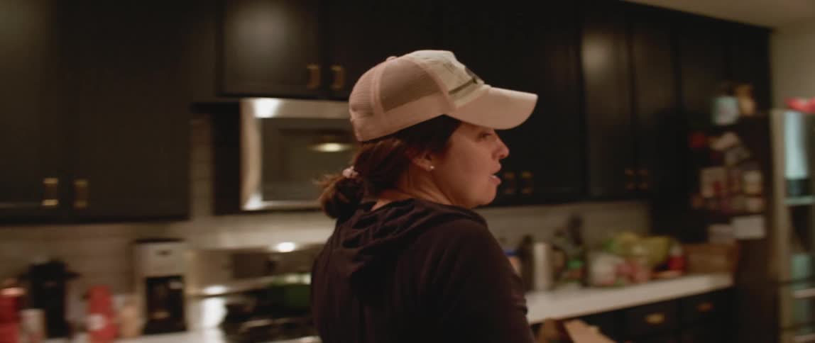 A mom talks to her kids in the kitchen