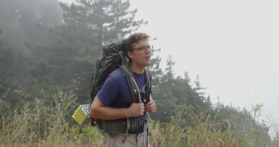 A man wearing a backpack struggles to keep moving
