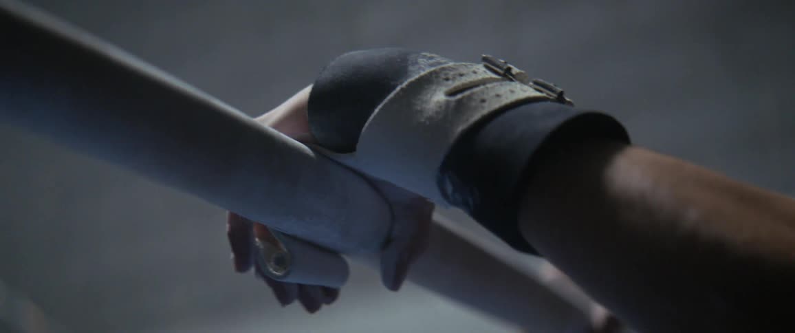 Hand grabs onto a beam while wearing a wrist protector