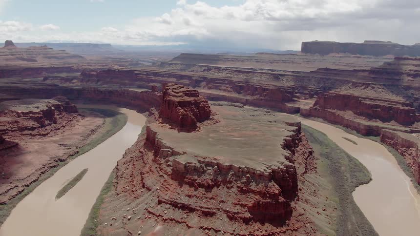 A river is winding its way through a canyon on a cloudy day