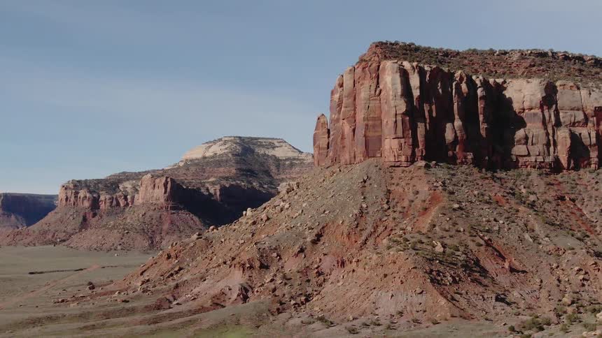 Flat topped hills sit under a blue sky