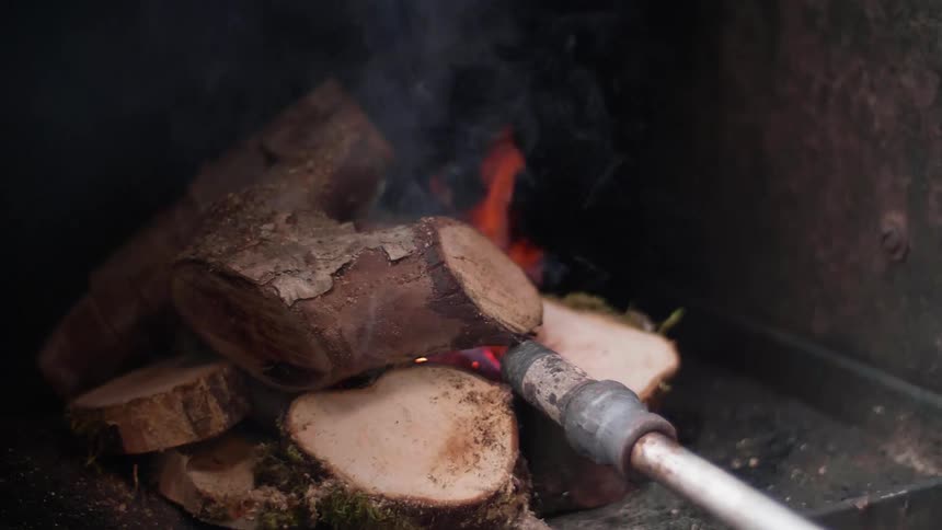 The wood is beginning to burn in the oven