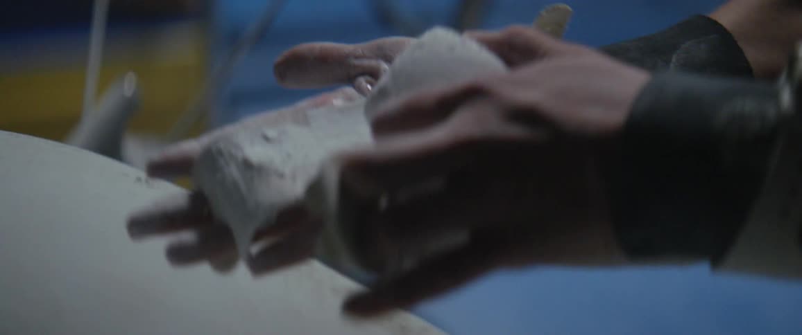 Two hands scrub a bar of soap between them