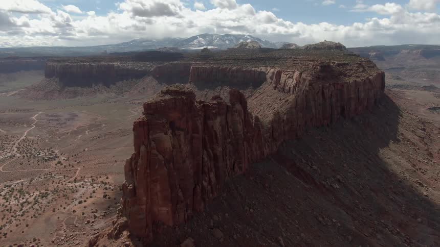 Rock formations and cliffs stand in a desert