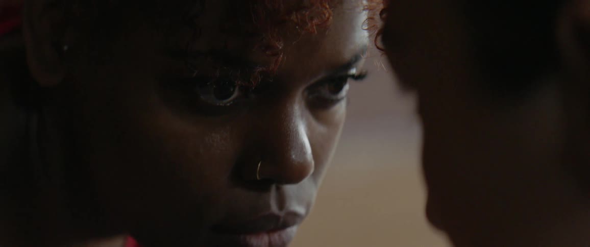 Two women stare intensely at each other with their faces close together