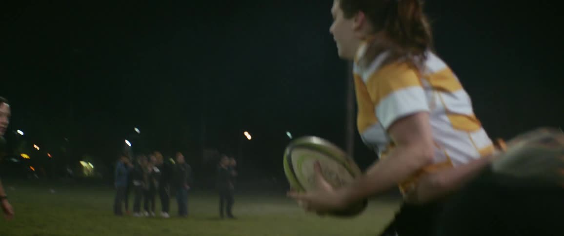 People playing soccer outside at night