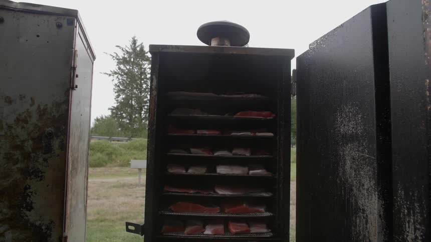 Meat is cooked in an outdoor smoker