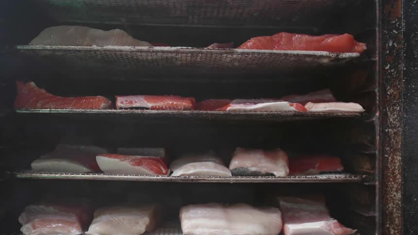 Meat is cooking on the grills in the oven
