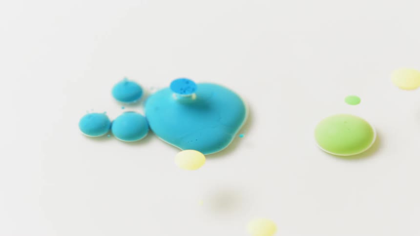Blobs of bright colors are dripping into a clear liquid
