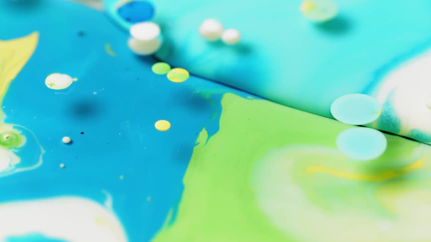 Blue, green and yellow liquid float on the surface