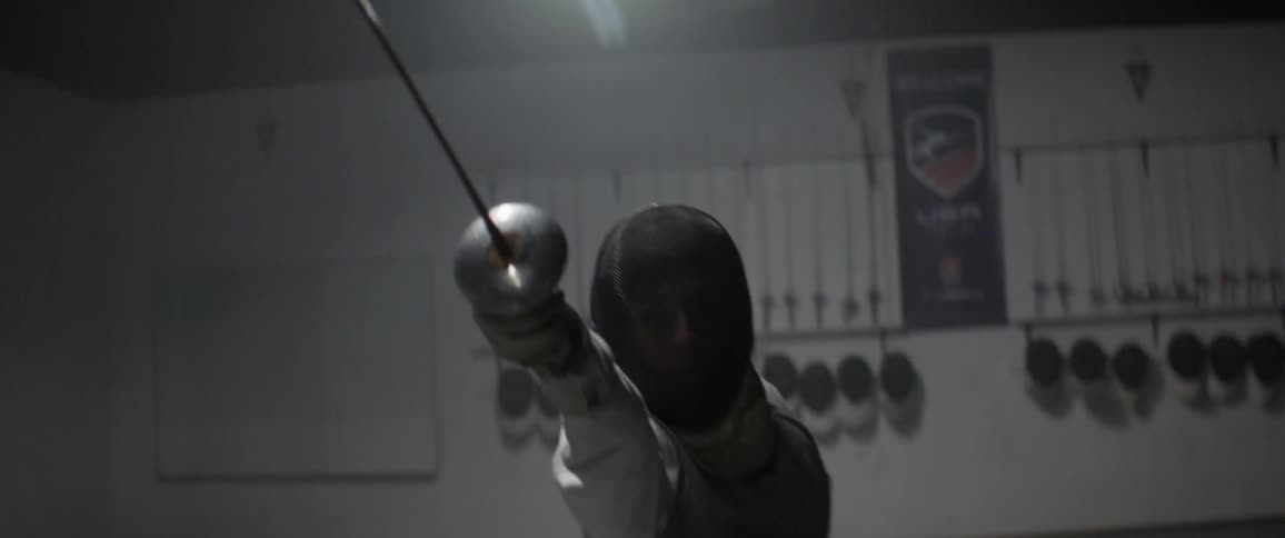 An athlete fences indoors