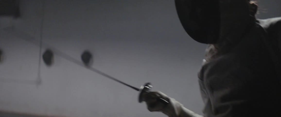 Two people are fencing