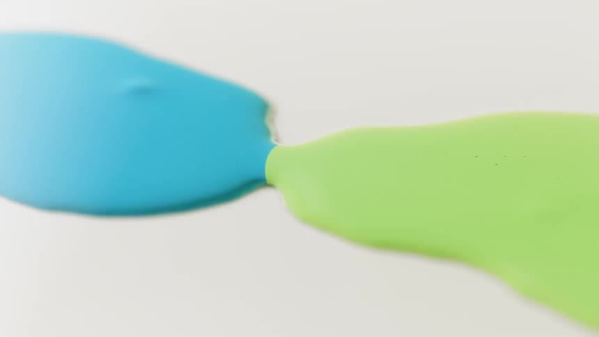 Blue liquid and green liquid spread towards each other