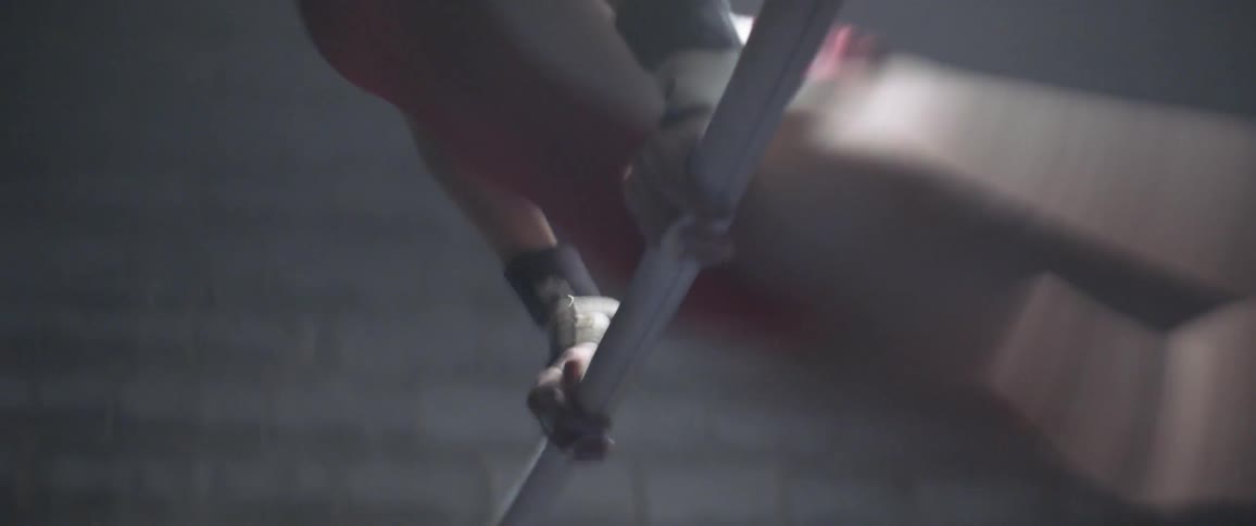 The woman spins and turns on the gymnastic bar