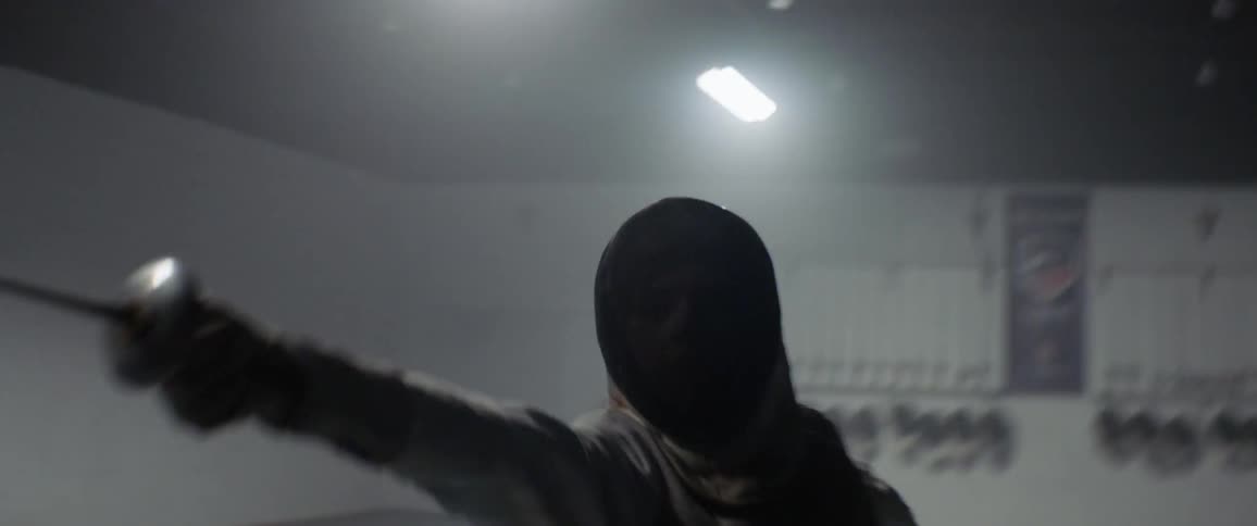 Person practices fencing while wearing a protective mask