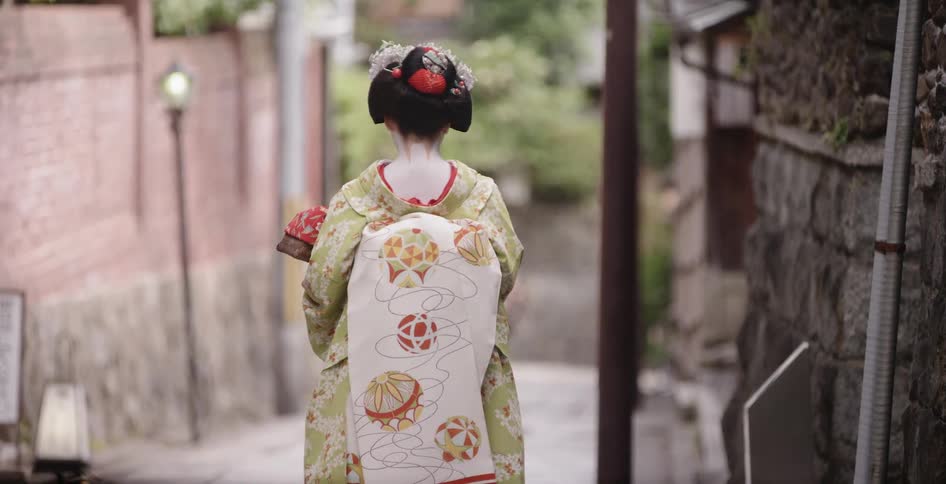 Woman in a kimono walks down the street