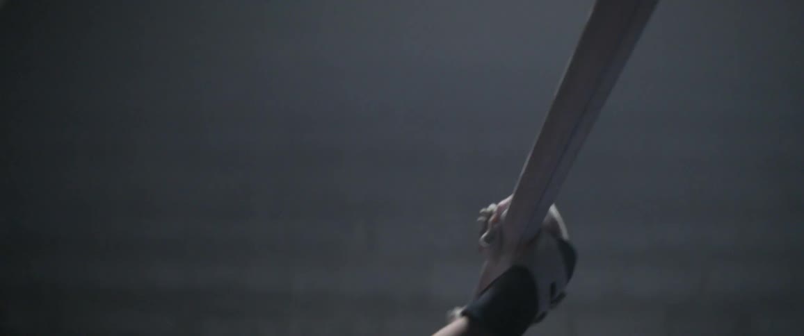 A woman grabs the bar and begins gymnastics