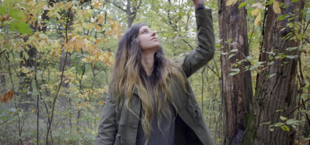 A man and woman hike in a forest