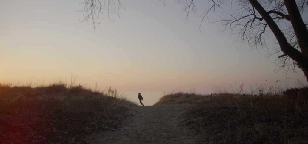 Young child runs down a dirt path