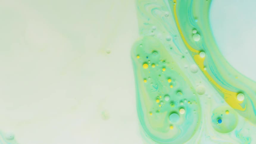 Yellow and blue bubbles float in the liquid