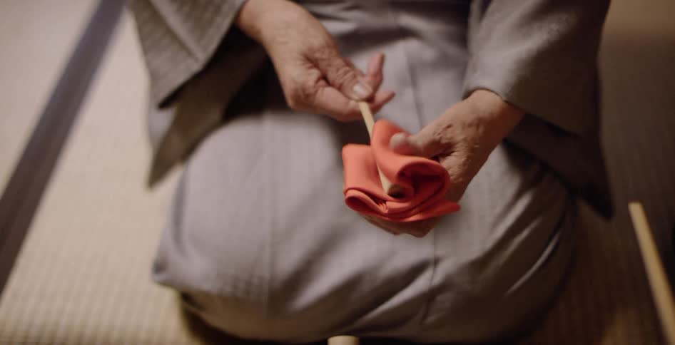 A person is folding a napkin