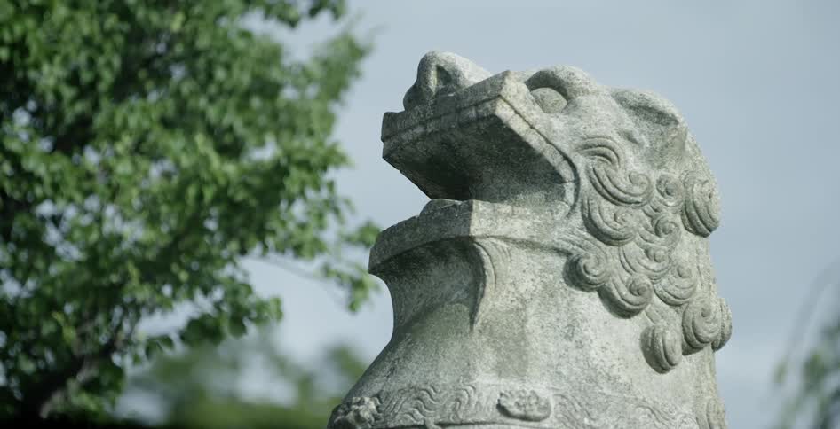 A statue of a lion near some trees