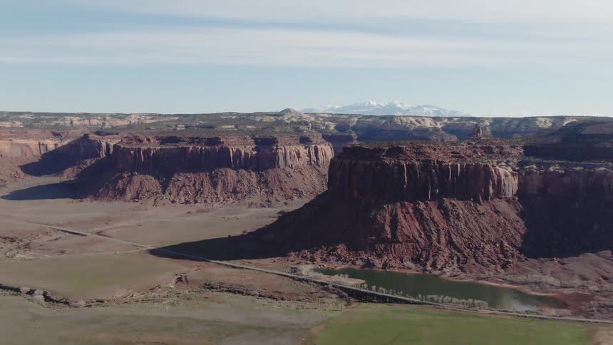 A small pool of water sits next to the canyon