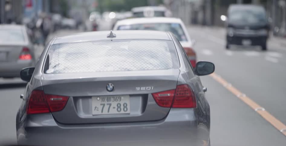 Cars travel down a busy city street