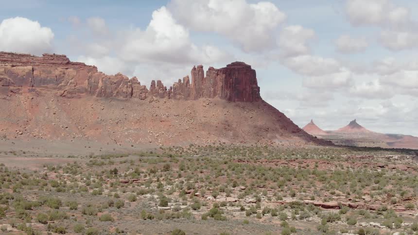 Bushy desert land with large rocky mountains