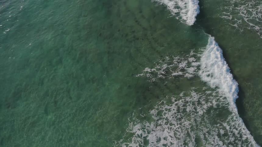 Waves flow onto the beach shore